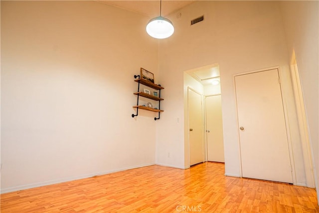 9620 Sepulveda Blvd Unit 4, North Hills, CA 91343 - empty room featuring light wood-type flooring and a towering ceiling