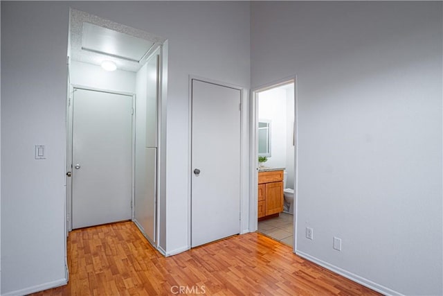 9620 Sepulveda Blvd Unit 4, North Hills, CA 91343 - unfurnished bedroom with light wood-style flooring, connected bathroom, a closet, and attic access