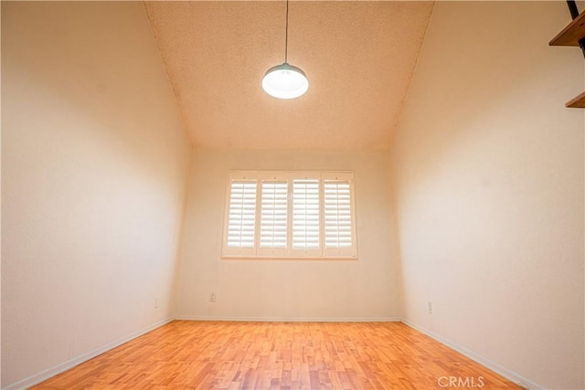 9620 Sepulveda Blvd Unit 4, North Hills, CA 91343 - unfurnished room with wood finished floors, lofted ceiling, and a textured ceiling