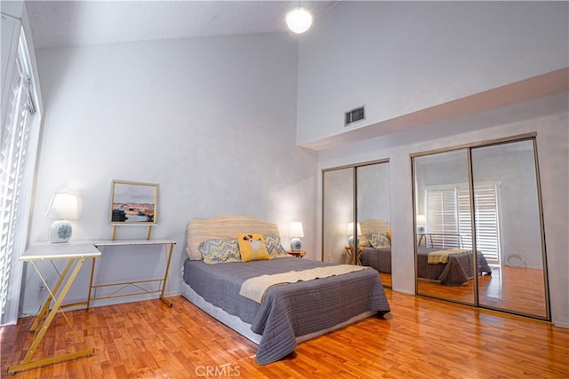 9620 Sepulveda Blvd Unit 4, North Hills, CA 91343 - bedroom with two closets, wood finished floors, and high vaulted ceiling