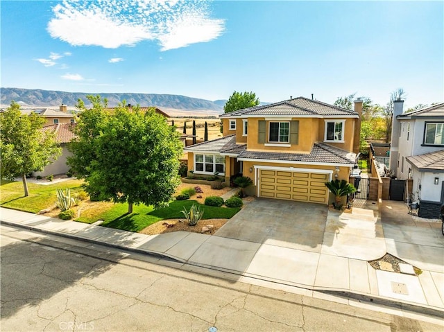 43145 62nd St W, Lancaster, CA 93536 - traditional-style home featuring a tile roof, stucco siding, concrete driveway, a garage, and a mountain view