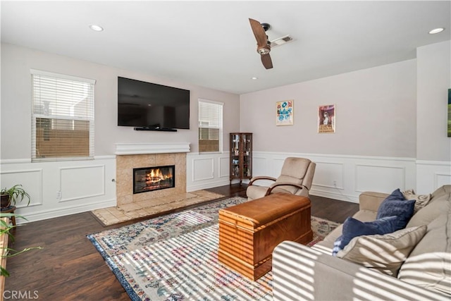 43145 62nd St W, Lancaster, CA 93536 - living area with wood finished floors, a wainscoted wall, a ceiling fan, a tiled fireplace, and a decorative wall