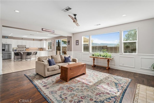 43145 62nd St W, Lancaster, CA 93536 - living area featuring a ceiling fan, a wainscoted wall, a decorative wall, recessed lighting, and light wood-style flooring