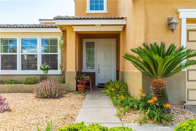 43145 62nd St W, Lancaster, CA 93536 - view of exterior entry featuring stucco siding and a tiled roof
