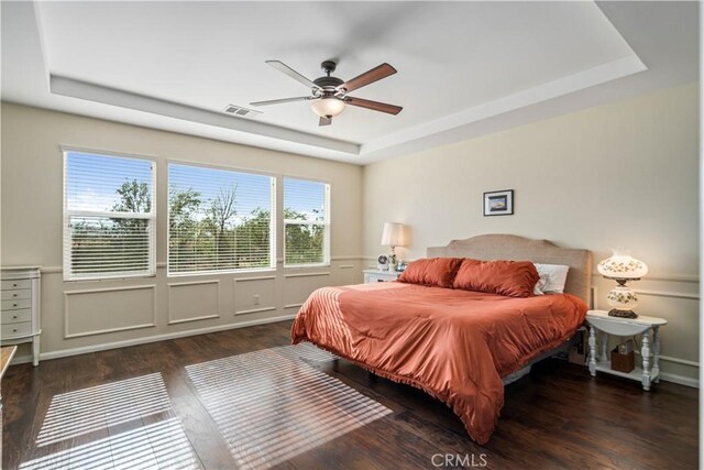 43145 62nd St W, Lancaster, CA 93536 - bedroom with a tray ceiling, wood finished floors, a decorative wall, and a ceiling fan