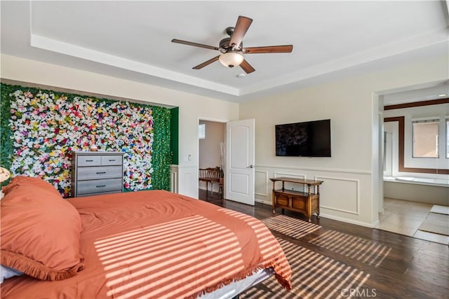 43145 62nd St W, Lancaster, CA 93536 - bedroom with wood finished floors, a raised ceiling, a wainscoted wall, ensuite bathroom, and a decorative wall