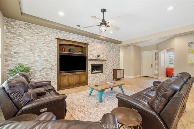 79787 Parkway Esplanade N, La Quinta, CA 92253 - living area with ceiling fan, arched walkways, recessed lighting, a fireplace, and light tile patterned flooring