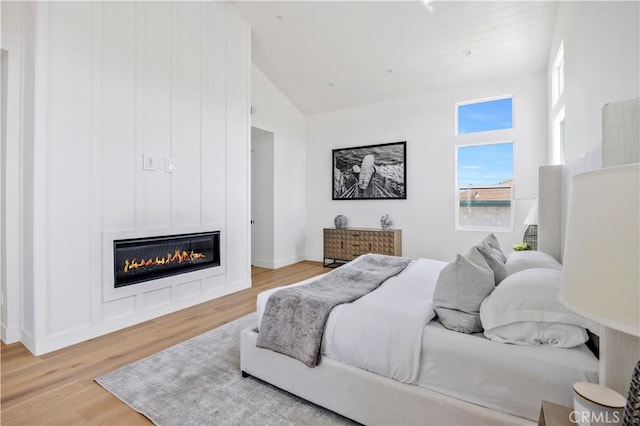 2102 Marshallfield Ln Unit B, Redondo Beach, CA 90278 - bedroom featuring wood finished floors, a fireplace, and high vaulted ceiling