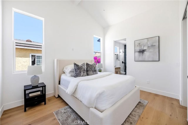 2102 Marshallfield Ln Unit B, Redondo Beach, CA 90278 - bedroom with light wood finished floors, high vaulted ceiling, and ensuite bath