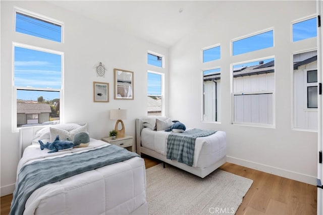 2102 Marshallfield Ln Unit B, Redondo Beach, CA 90278 - bedroom with multiple windows, wood finished floors, and a high ceiling