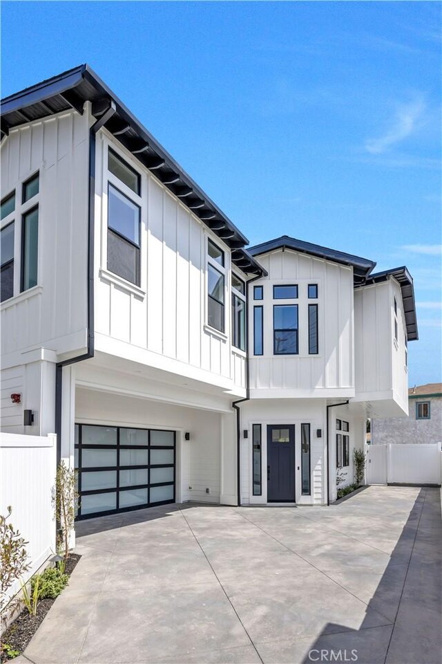 2102 Marshallfield Ln Unit B, Redondo Beach, CA 90278 - view of front of property with board and batten siding, a garage, and concrete driveway