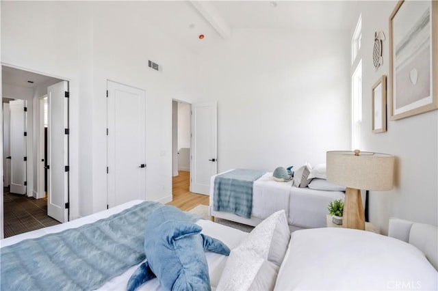 2102 Marshallfield Ln Unit B, Redondo Beach, CA 90278 - bedroom featuring a towering ceiling, beam ceiling, and wood finished floors