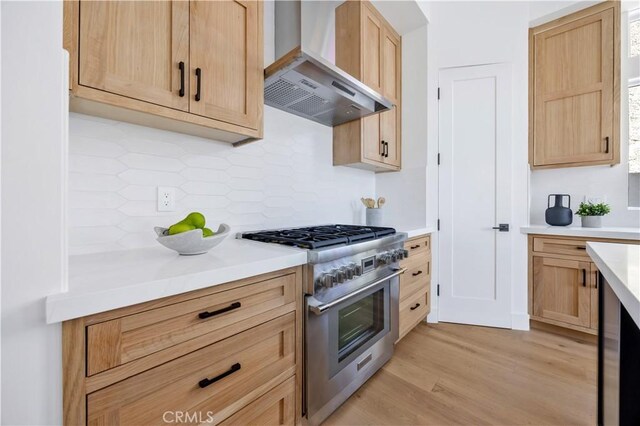 2102 Marshallfield Ln Unit B, Redondo Beach, CA 90278 - kitchen featuring high end stainless steel range oven, wall chimney exhaust hood, tasteful backsplash, and light brown cabinetry