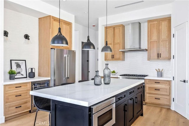 2102 Marshallfield Ln Unit B, Redondo Beach, CA 90278 - kitchen featuring wall chimney exhaust hood, beverage cooler, appliances with stainless steel finishes, tasteful backsplash, and light wood-style floors
