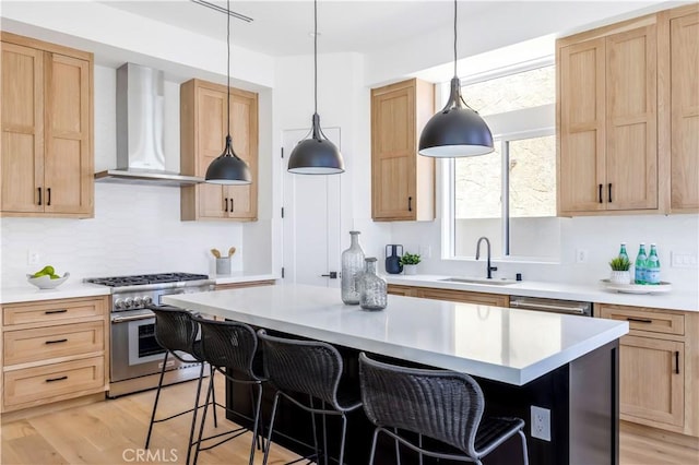 2102 Marshallfield Ln Unit B, Redondo Beach, CA 90278 - kitchen with high end range, wall chimney range hood, light brown cabinetry, light countertops, and a kitchen breakfast bar