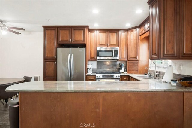 631 7th St Unit 11, Imperial Beach, CA 91932 - kitchen with stainless steel appliances, light stone countertops, a ceiling fan, decorative backsplash, and recessed lighting