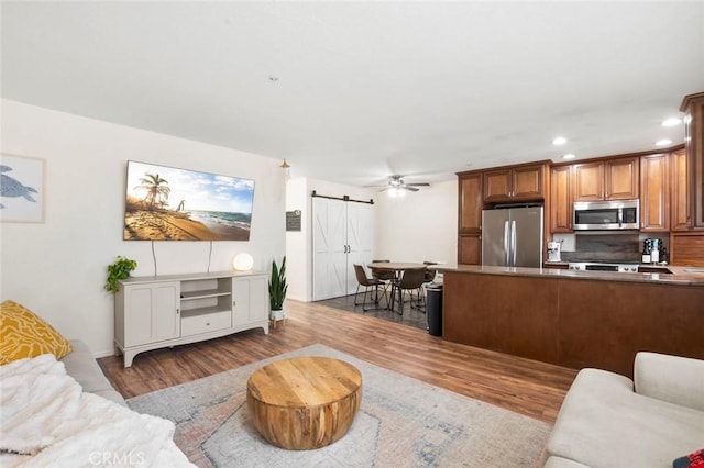 631 7th St Unit 11, Imperial Beach, CA 91932 - living room with a barn door, wood finished floors, recessed lighting, and ceiling fan