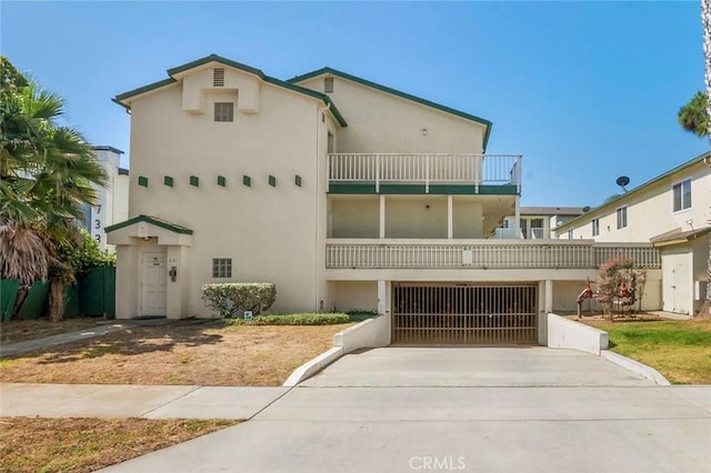 631 7th St Unit 11, Imperial Beach, CA 91932 - view of front of house with a balcony, stucco siding, a garage, and concrete driveway