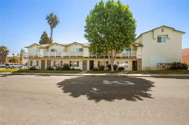 631 7th St Unit 11, Imperial Beach, CA 91932 - view of front facade with stucco siding and a balcony