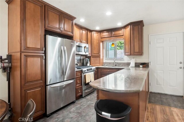 631 7th St Unit 11, Imperial Beach, CA 91932 - kitchen featuring stainless steel appliances, a peninsula, brown cabinetry, and recessed lighting