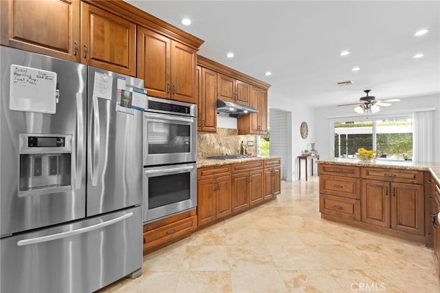 1907 W 235th Pl, Torrance, CA 90501 - kitchen with stainless steel appliances, recessed lighting, brown cabinetry, under cabinet range hood, and tasteful backsplash