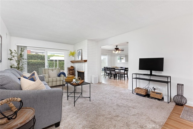 1907 W 235th Pl, Torrance, CA 90501 - living area featuring ceiling fan, a brick fireplace, wood finished floors, and a textured ceiling