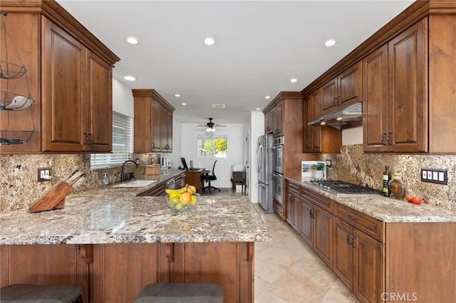 1907 W 235th Pl, Torrance, CA 90501 - kitchen with stainless steel appliances, a peninsula, light stone countertops, backsplash, and a ceiling fan