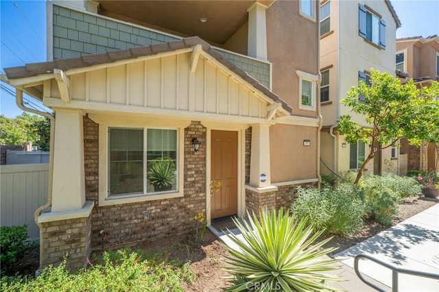 797 Plum Ln, Pomona, CA 91767 - view of front of home with board and batten siding, brick siding, and stucco siding