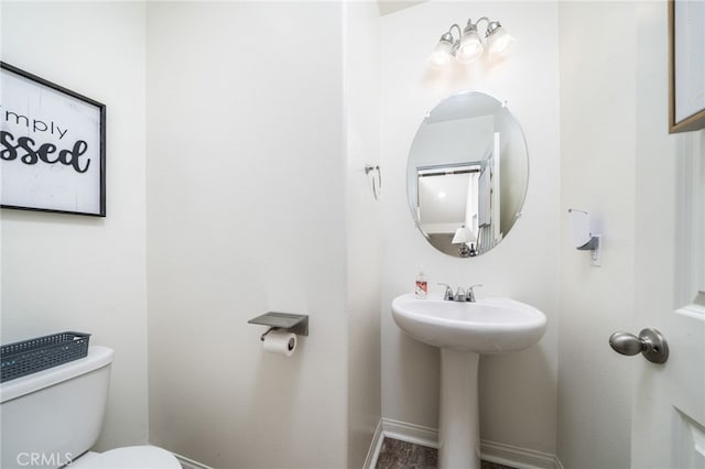 797 Plum Ln, Pomona, CA 91767 - bathroom featuring toilet and baseboards