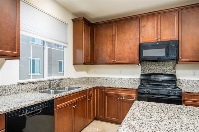 797 Plum Ln, Pomona, CA 91767 - kitchen featuring black appliances, light stone countertops, and light tile patterned flooring
