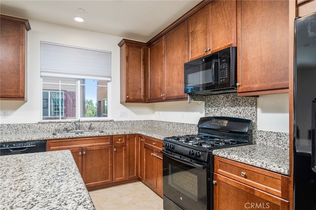 797 Plum Ln, Pomona, CA 91767 - kitchen featuring black appliances, light stone counters, recessed lighting, light tile patterned floors, and brown cabinetry