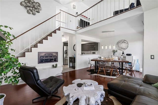 1237 E 6th St Unit 306, Long Beach, CA 90802 - living room featuring hardwood / wood-style floors, stairway, and a high ceiling