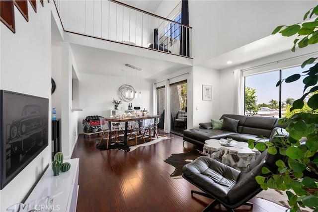 1237 E 6th St Unit 306, Long Beach, CA 90802 - living area featuring healthy amount of natural light, wood finished floors, and a towering ceiling