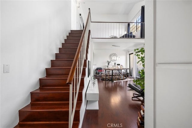 1237 E 6th St Unit 306, Long Beach, CA 90802 - stairway with a towering ceiling and hardwood / wood-style flooring