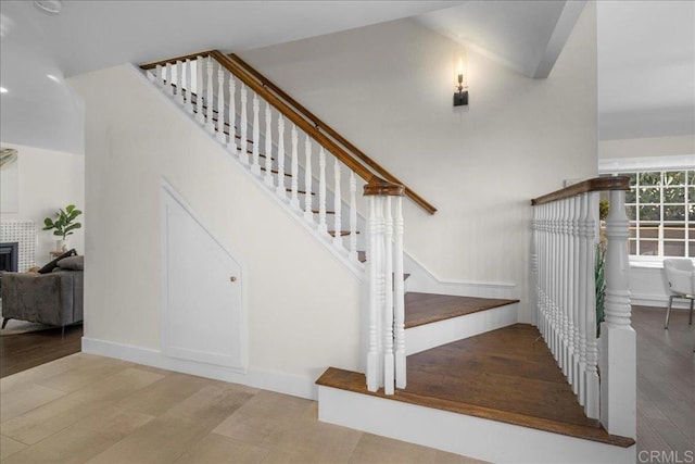 9858 Via Caceres, San Diego, CA 92129 - stairs featuring wood finished floors and a tiled fireplace