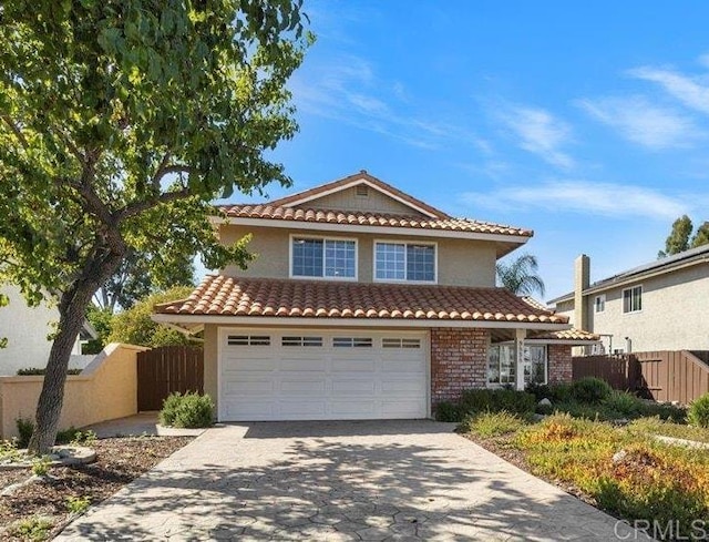 9858 Via Caceres, San Diego, CA 92129 - traditional home featuring a tile roof, driveway, stucco siding, and an attached garage
