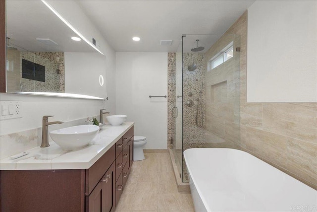 9858 Via Caceres, San Diego, CA 92129 - bathroom with a stall shower, double vanity, a soaking tub, and recessed lighting