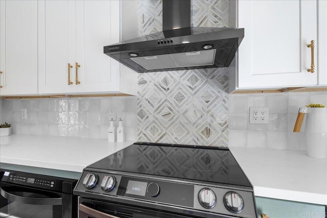 9858 Via Caceres, San Diego, CA 92129 - kitchen with black electric range, wall chimney exhaust hood, light countertops, white cabinets, and decorative backsplash