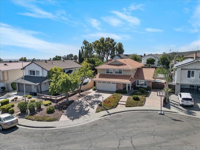 9858 Via Caceres, San Diego, CA 92129 - view of front of house featuring a residential view, driveway, a tile roof, and a garage