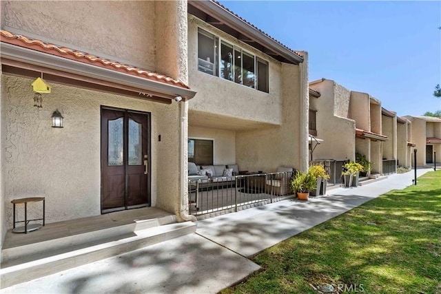9436 Via Monique, Burbank, CA 91504 - view of exterior entry featuring stucco siding, a tiled roof, and a patio