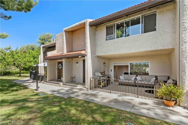 9436 Via Monique, Burbank, CA 91504 - rear view of property with stucco siding, outdoor lounge area, a tile roof, and a patio