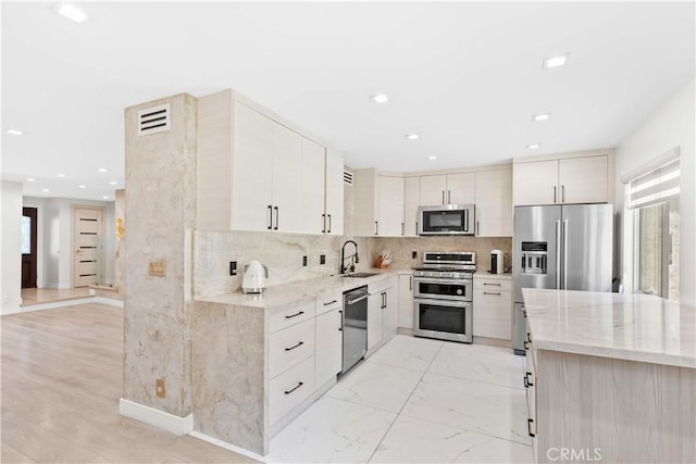 9436 Via Monique, Burbank, CA 91504 - kitchen featuring stainless steel appliances, light stone counters, recessed lighting, and tasteful backsplash