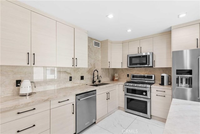 9436 Via Monique, Burbank, CA 91504 - kitchen featuring appliances with stainless steel finishes, light marble finish floors, backsplash, light stone countertops, and recessed lighting