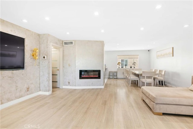 9436 Via Monique, Burbank, CA 91504 - living area with wood finished floors, a glass covered fireplace, and recessed lighting