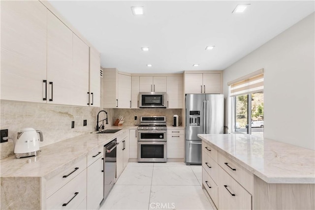 9436 Via Monique, Burbank, CA 91504 - kitchen featuring appliances with stainless steel finishes, light marble finish flooring, light stone countertops, tasteful backsplash, and recessed lighting