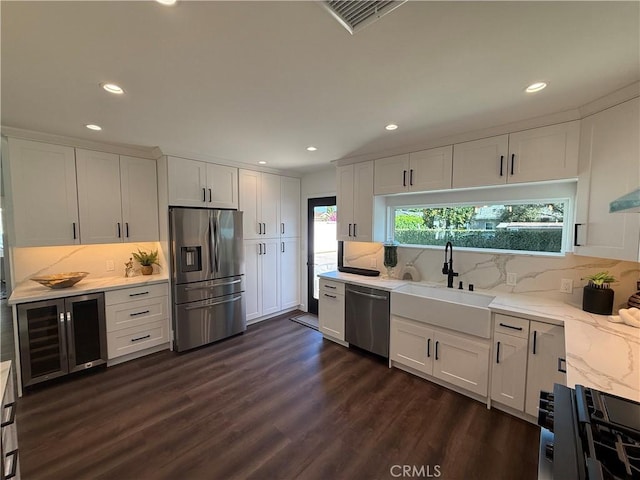 17532 Hamlin St, Lake Balboa, CA 91406 - kitchen featuring appliances with stainless steel finishes, white cabinets, recessed lighting, and backsplash