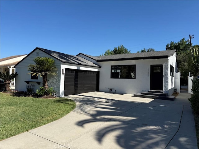 17532 Hamlin St, Lake Balboa, CA 91406 - view of front of home featuring a garage, stucco siding, a front lawn, concrete driveway, and entry steps