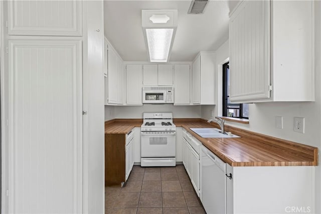 18165 Sundowner Way Unit 914, Canyon Country, CA 91387 - kitchen with white appliances, white cabinetry, and dark tile patterned floors