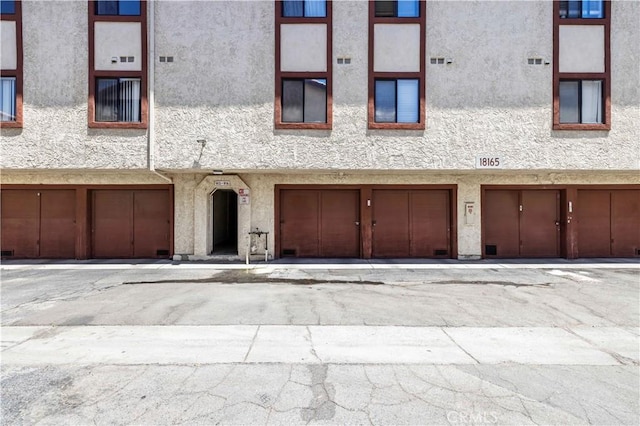 18165 Sundowner Way Unit 914, Canyon Country, CA 91387 - view of front of house featuring stucco siding and a garage
