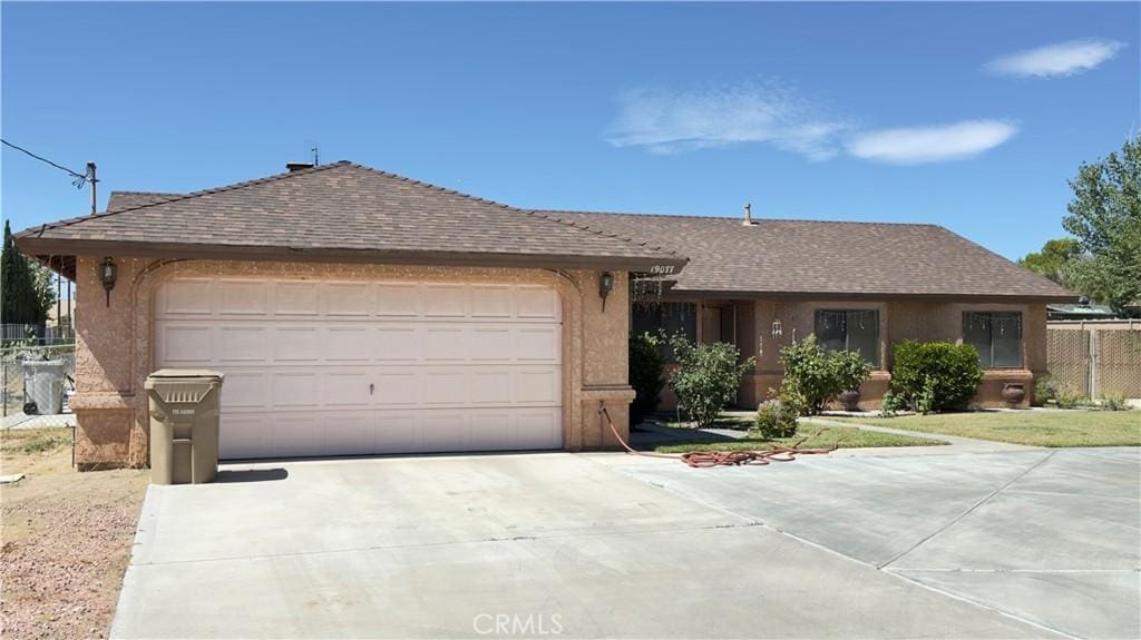 19077 Goleta St, Hesperia, CA 92345 - ranch-style home featuring driveway, a garage, stucco siding, and a shingled roof